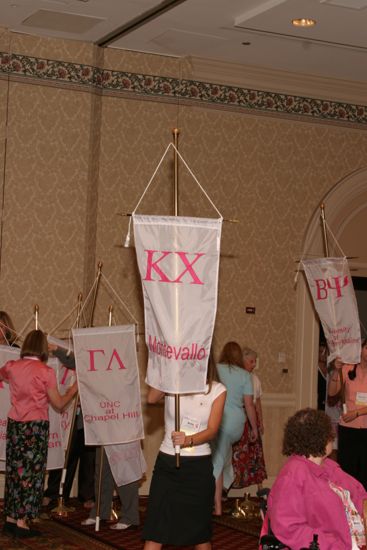 Unidentified Phi Mu With Kappa Chi Chapter Banner in Convention Parade of Flags Photograph, July 9, 2004 (image)