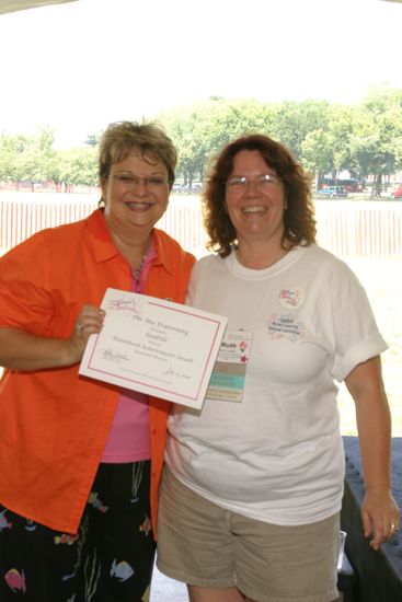 Kathy Williams and Seattle Alumna With Certificate at Convention Outdoor Luncheon Photograph, July 10, 2004 (image)