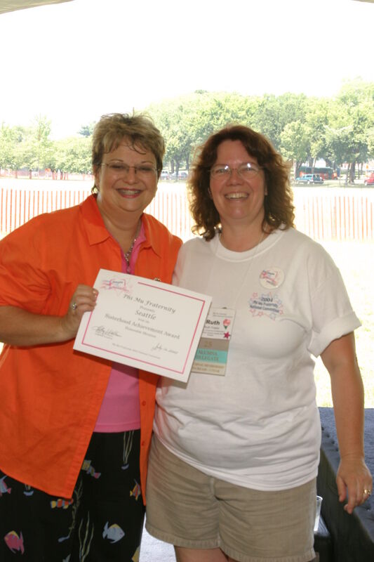 Kathy Williams and Seattle Alumna With Certificate at Convention Outdoor Luncheon Photograph, July 10, 2004 (Image)