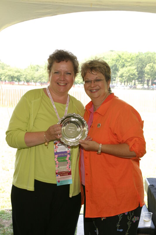 Audrey Jankucic and Kathy Williams With Award at Convention Outdoor Luncheon Photograph 2, July 10, 2004 (Image)