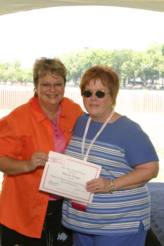 Kathy Williams and Baton Rouge Alumna With Certificate at Convention Outdoor Luncheon Photograph, July 10, 2004 (Image)