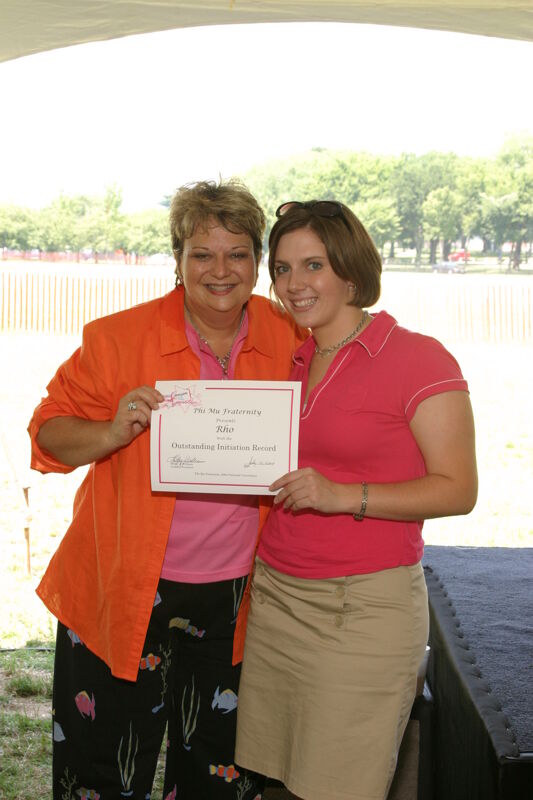 Kathy Williams and Rho Chapter Member With Certificate at Convention Outdoor Luncheon Photograph, July 10, 2004 (Image)
