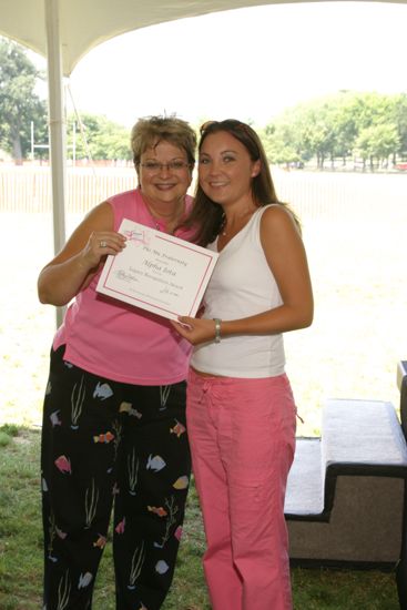 Kathy Williams and Alpha Iota Chapter Member With Certificate at Convention Outdoor Luncheon Photograph, July 10, 2004 (image)