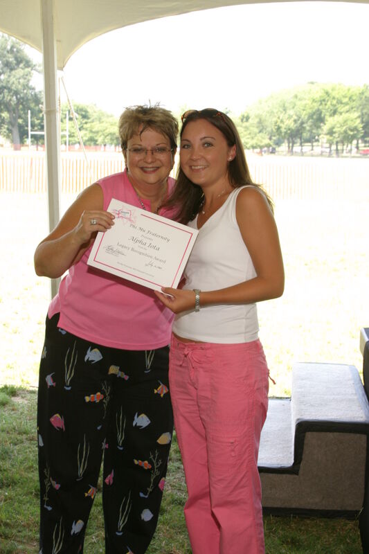Kathy Williams and Alpha Iota Chapter Member With Certificate at Convention Outdoor Luncheon Photograph, July 10, 2004 (Image)