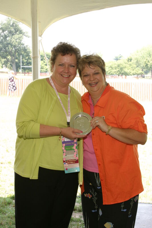 Audrey Jankucic and Kathy Williams With Award at Convention Outdoor Luncheon Photograph 3, July 10, 2004 (Image)
