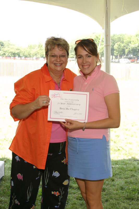 Kathy Williams and Beta Mu Chapter Member With Certificate at Convention Outdoor Luncheon Photograph, July 10, 2004 (Image)