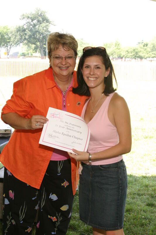 Kathy Williams and Alpha Epsilon Chapter Member With Certificate at Convention Outdoor Luncheon Photograph, July 10, 2004 (Image)