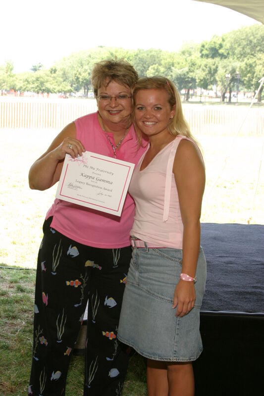Kathy Williams and Kappa Gamma Chapter Member With Certificate at Convention Outdoor Luncheon Photograph 1, July 10, 2004 (Image)