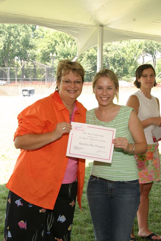 Kathy Williams and Epsilon Mu Chapter Member With Certificate at Convention Outdoor Luncheon Photograph, July 10, 2004 (Image)