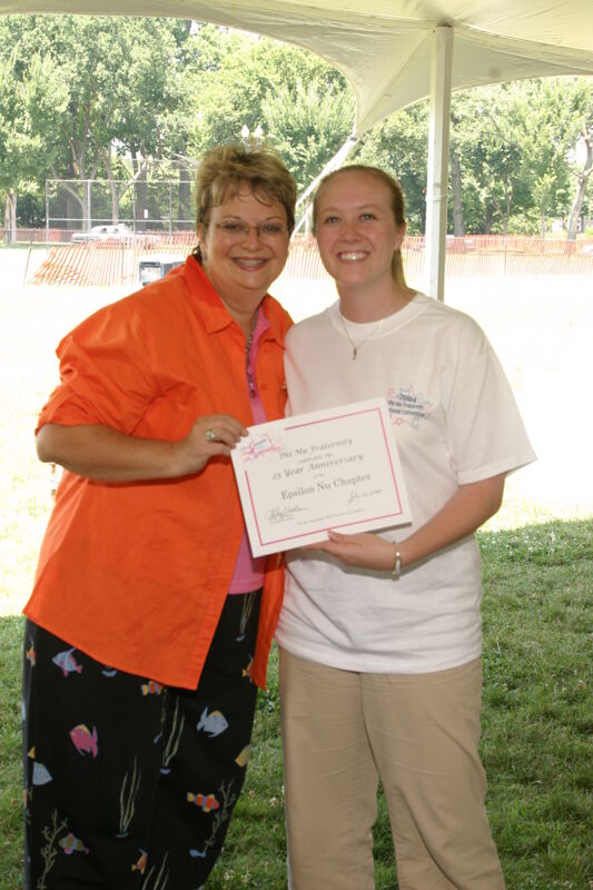 Kathy Williams and Epsilon Nu Chapter Member With Certificate at Convention Outdoor Luncheon Photograph 2, July 10, 2004 (Image)