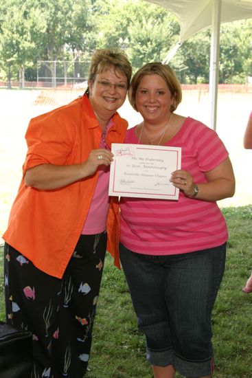 Kathy Williams and Cory Hurt With Certificate at Convention Outdoor Luncheon Photograph, July 10, 2004 (image)