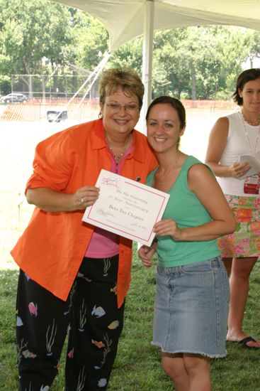 Kathy Williams and Beta Tau Chapter Member With Certificate at Convention Outdoor Luncheon Photograph, July 10, 2004 (image)