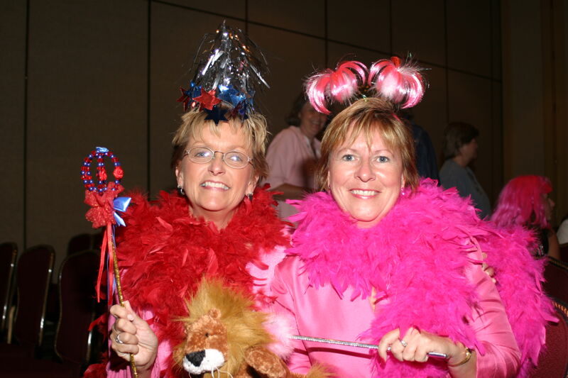 Two Unidentified Phi Mus in Feather Boas at Convention Officer Appreciation Luncheon Photograph, July 8, 2004 (Image)
