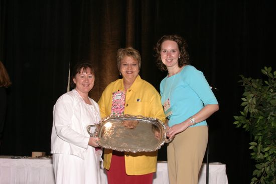 Kathy Williams and Two Unidentified Phi Mus With Award at Convention Sisterhood Luncheon Photograph, July 8-11, 2004 (image)