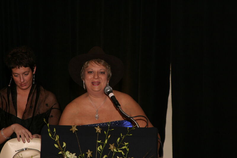 Jen Wooley and Kathy Williams With Hats at Convention Carnation Banquet Photograph, July 11, 2004 (Image)