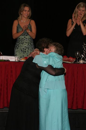 Audrey Jankucic and Unidentified Phi Mu Hugging at Convention Carnation Banquet Photograph 1, July 11, 2004 (image)