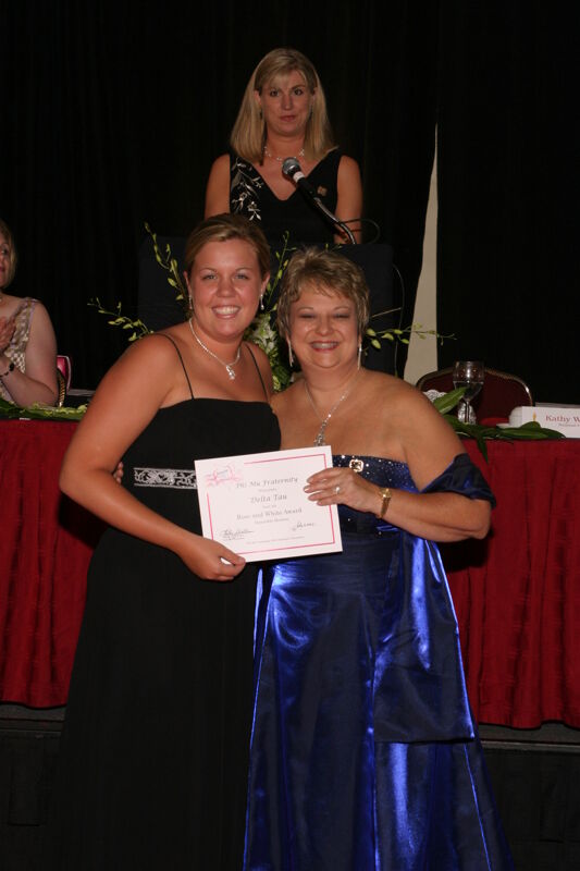 Kathy Williams and Delta Tau Chapter Member With Certificate at Convention Carnation Banquet Photograph, July 11, 2004 (Image)