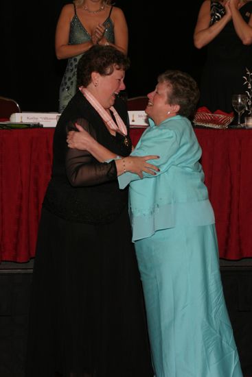 Audrey Jankucic and Unidentified Phi Mu Hugging at Convention Carnation Banquet Photograph 3, July 11, 2004 (image)