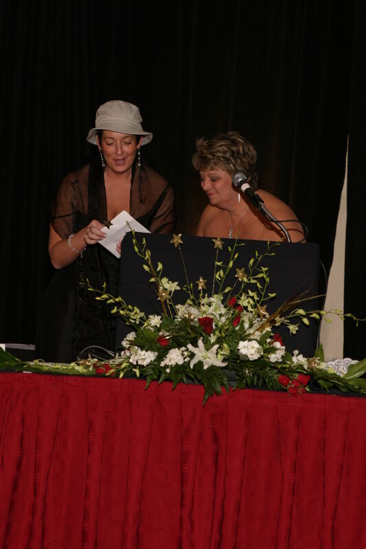 Jen Wooley and Kathy Williams With Envelope at Convention Carnation Banquet Photograph 2, July 11, 2004 (Image)