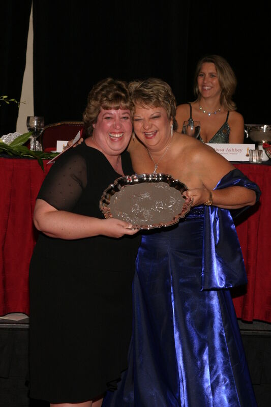 Kathy Williams and Unidentified With Award at Convention Carnation Banquet Photograph 7, July 11, 2004 (Image)