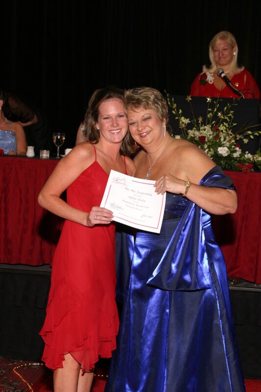 Kathy Williams and Alpha Delta Chapter Member With Certificate at Convention Carnation Banquet Photograph, July 11, 2004 (Image)