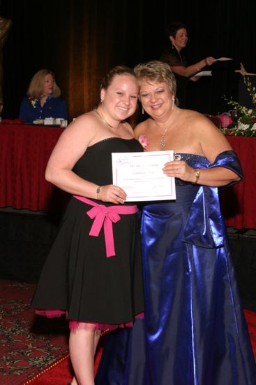 Kathy Williams and Lambda Eta Chapter Member With Certificate at Convention Carnation Banquet Photograph, July 11, 2004 (image)