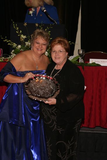 Kathy Williams and Unidentified With Award at Convention Carnation Banquet Photograph 8, July 11, 2004 (image)