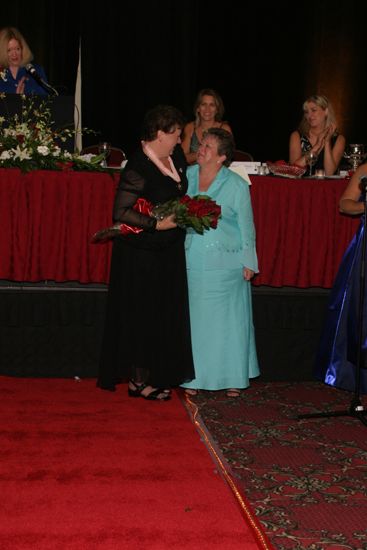 Audrey Jankucic and Unidentified Phi Mu Hugging at Convention Carnation Banquet Photograph 4, July 11, 2004 (image)