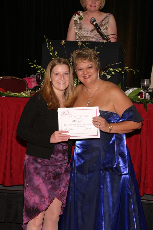 Kathy Williams and Rho Delta Chapter Member With Certificate at Convention Carnation Banquet Photograph, July 11, 2004 (Image)