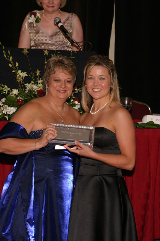 Kathy Williams and Unidentified With Award at Convention Carnation Banquet Photograph 20, July 11, 2004 (Image)