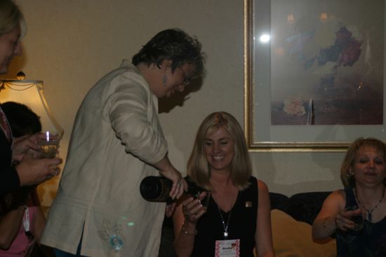 Kathy Williams Pouring a Drink for Andie Kash at Convention Officers' Party Photograph, July 7, 2004 (image)