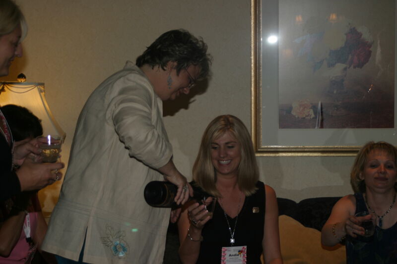 July 7 Kathy Williams Pouring a Drink for Andie Kash at Convention Officers' Party Photograph Image