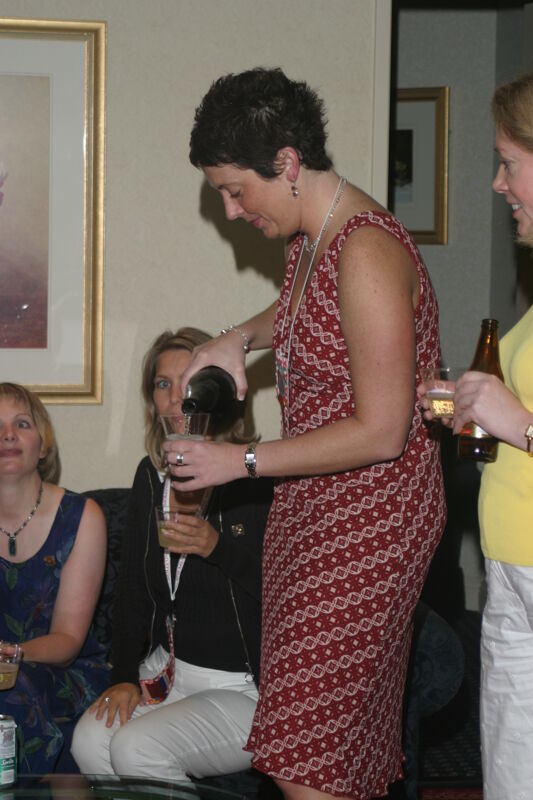 Jen Wooley Pouring a Drink at Convention Officers' Party Photograph, July 7, 2004 (Image)