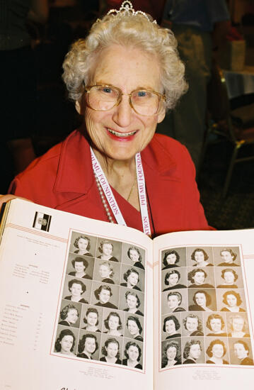 Anne Nelson With Old Yearbook at Convention Photograph 2, July 4-8, 2002 (image)