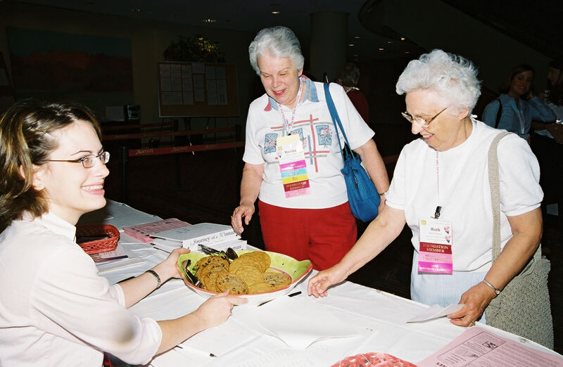 Ruth Proctor and Martha Lisle Selecting Cookies at Convention Photograph 1, July 4-8, 2002 (Image)