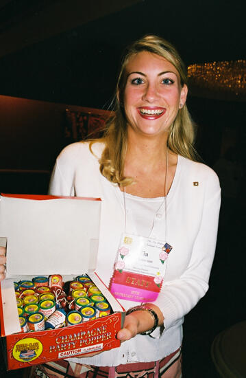 Tia Kneuvean Holding Box of Party Poppers at Convention Photograph, July 4, 2002 (image)