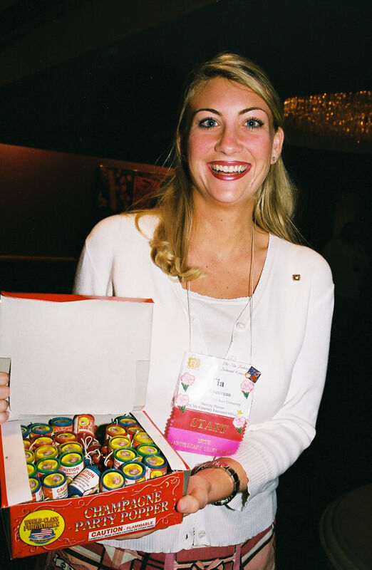 Tia Kneuvean Holding Box of Party Poppers at Convention Photograph, July 4, 2002 (Image)