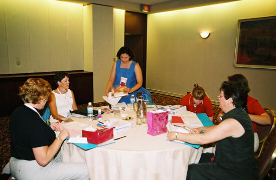 Table of Phi Mus Working at Convention Photograph, July 4-8, 2002 (image)