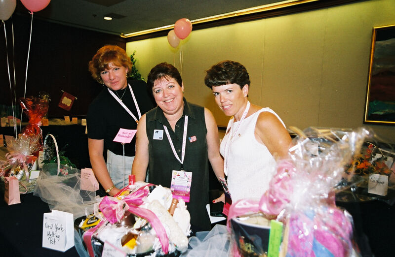 Unidentified, McNamara, and Straguzzi by Gift Baskets at Convention Photograph, July 4-8, 2002 (Image)