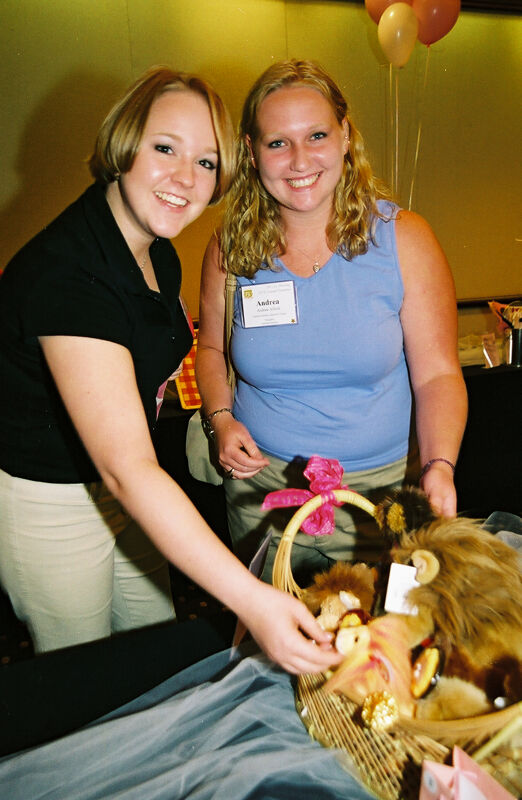 Unidentified and Andrea Alford with Gift Basket at Convention Photograph, July 4-8, 2002 (Image)