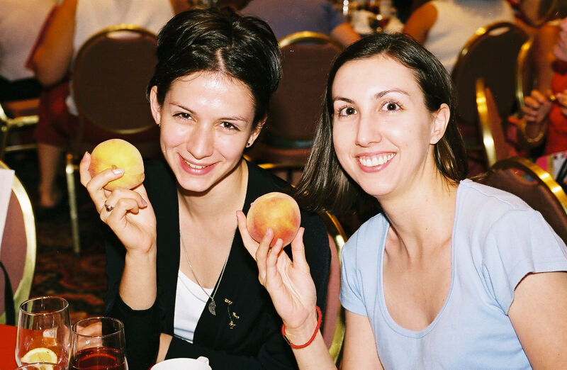 Two Phi Mus Holding Peaches at Convention Photograph 3, July 4-8, 2002 (Image)