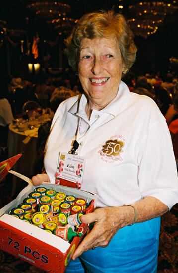 Elise Rawson Holding Box of Party Poppers at Convention Photograph, July 4, 2002 (image)