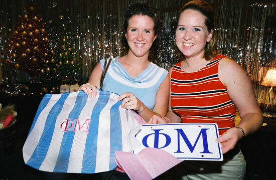 Two Members With Phi Mu Merchandise at Convention Photograph 2, July 4-8, 2002 (image)