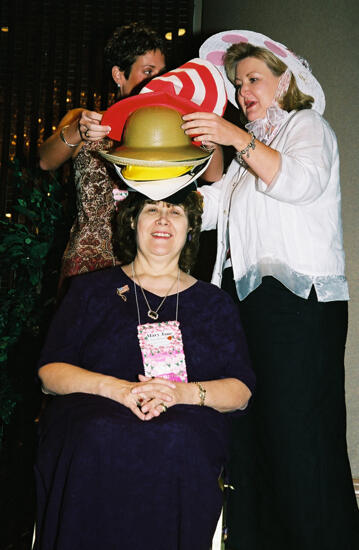 Wooley and Moore Placing Hat on Johnson at Convention Officers' Luncheon Photograph 3, July 4-8, 2002 (image)