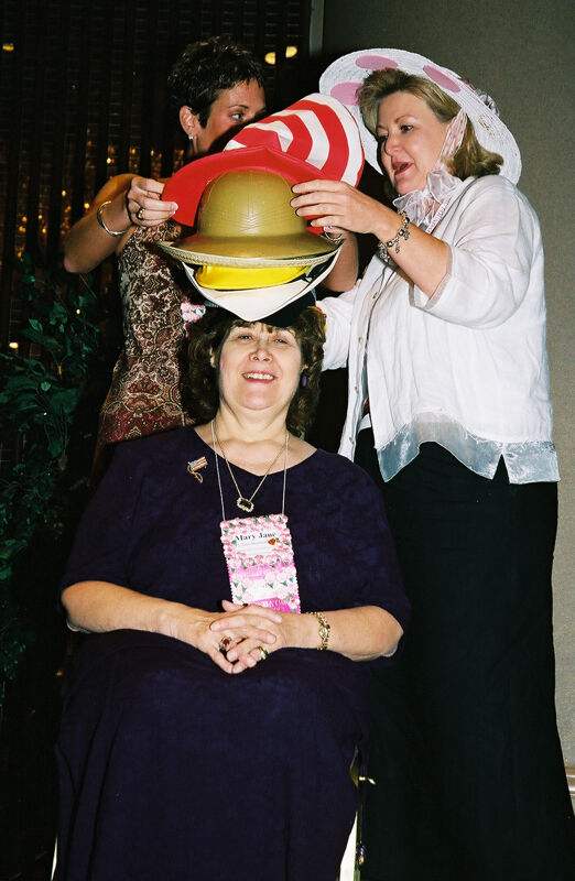 Wooley and Moore Placing Hat on Johnson at Convention Officers' Luncheon Photograph 3, July 4-8, 2002 (Image)