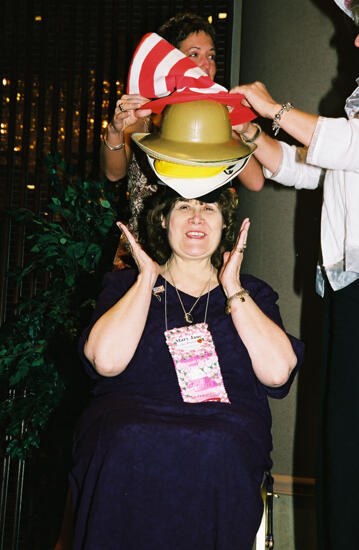 Mary Jane Johnson Wearing Multiple Hats at Convention Officers' Luncheon Photograph 6, July 4-8, 2002 (image)