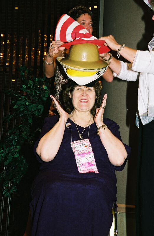 Mary Jane Johnson Wearing Multiple Hats at Convention Officers' Luncheon Photograph 6, July 4-8, 2002 (Image)
