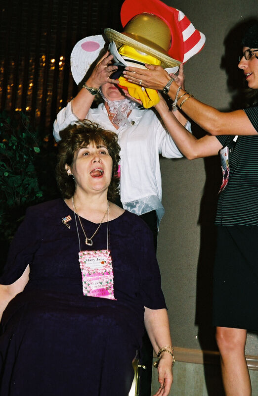 Mary Jane Johnson's Hats Being Removed at Convention Officers' Luncheon Photograph, July 4-8, 2002 (Image)