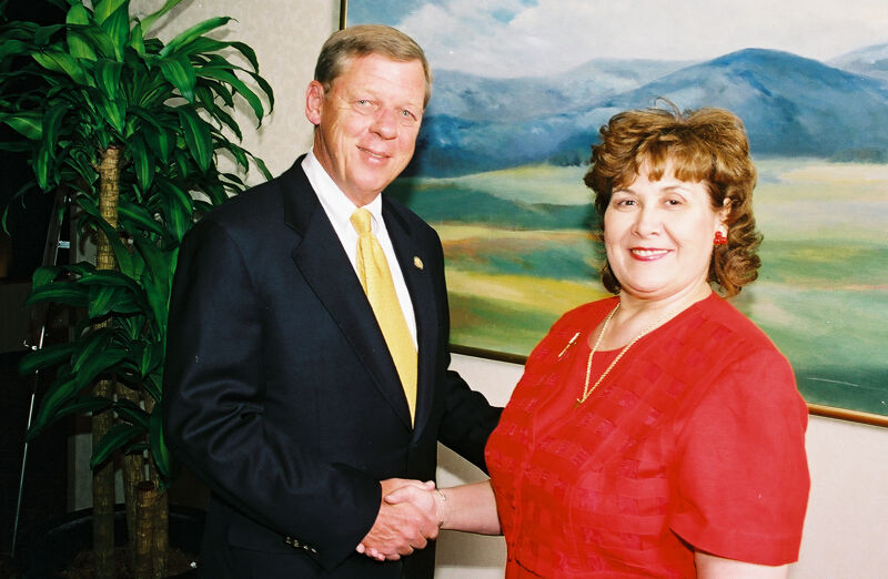 Johnny Isakson and Mary Jane Johnson Shaking Hands at Convention Photograph 3, July 4-8, 2002 (Image)