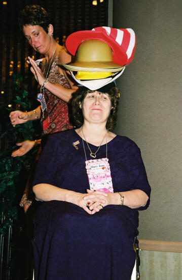 Mary Jane Johnson Wearing Multiple Hats at Convention Officers' Luncheon Photograph 7, July 4-8, 2002 (image)